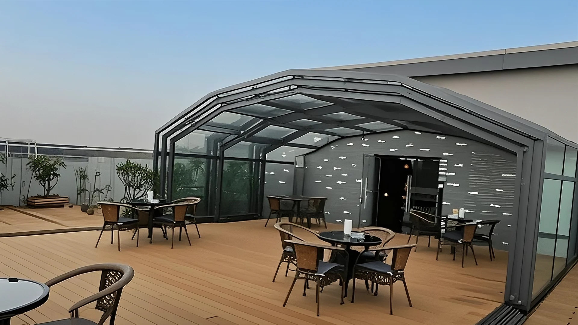 rooftop restaurant sunroom design with panoramic glass dining enclosure